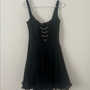 Elegant Black Mini Dress with Metallic Curved Accents